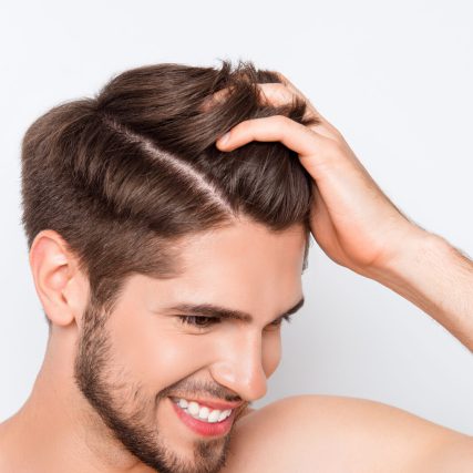 Man grip his fullgrown and natural healthy hair